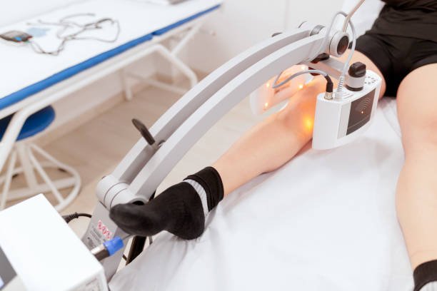 A diode laser machine being used on a patient's leg